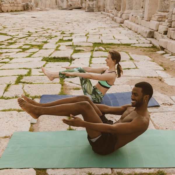 Diverse group of people smiling during a calm yoga session.